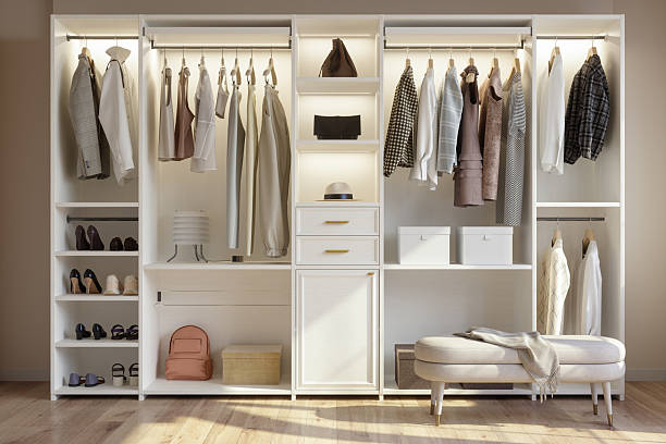 Front View Of Wardrobe With Shoes, Bags And Hanging Clothes. Modern Dressing Room
